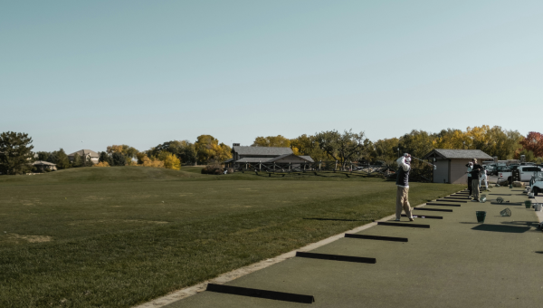 Golfer hitting balls on The VUE driving range