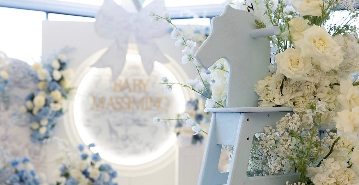 Blue and white floral shower decor with a balloon and bow display at The VUE