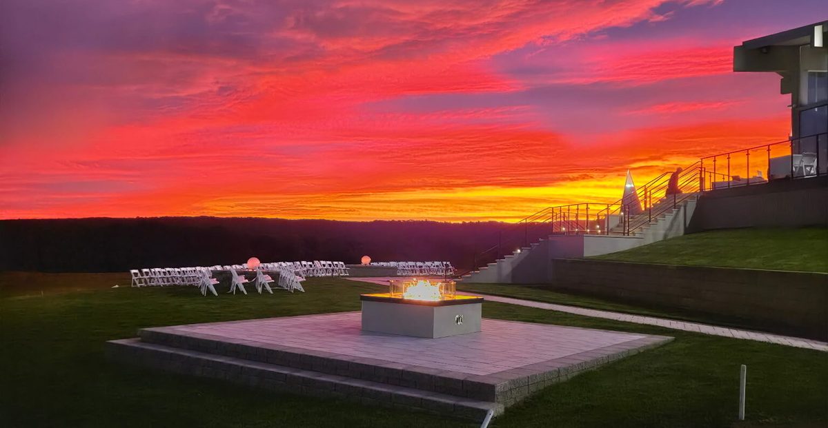 Vivid sunset over The VUE terrace and fire pit, a peaceful setting for a celebration of life