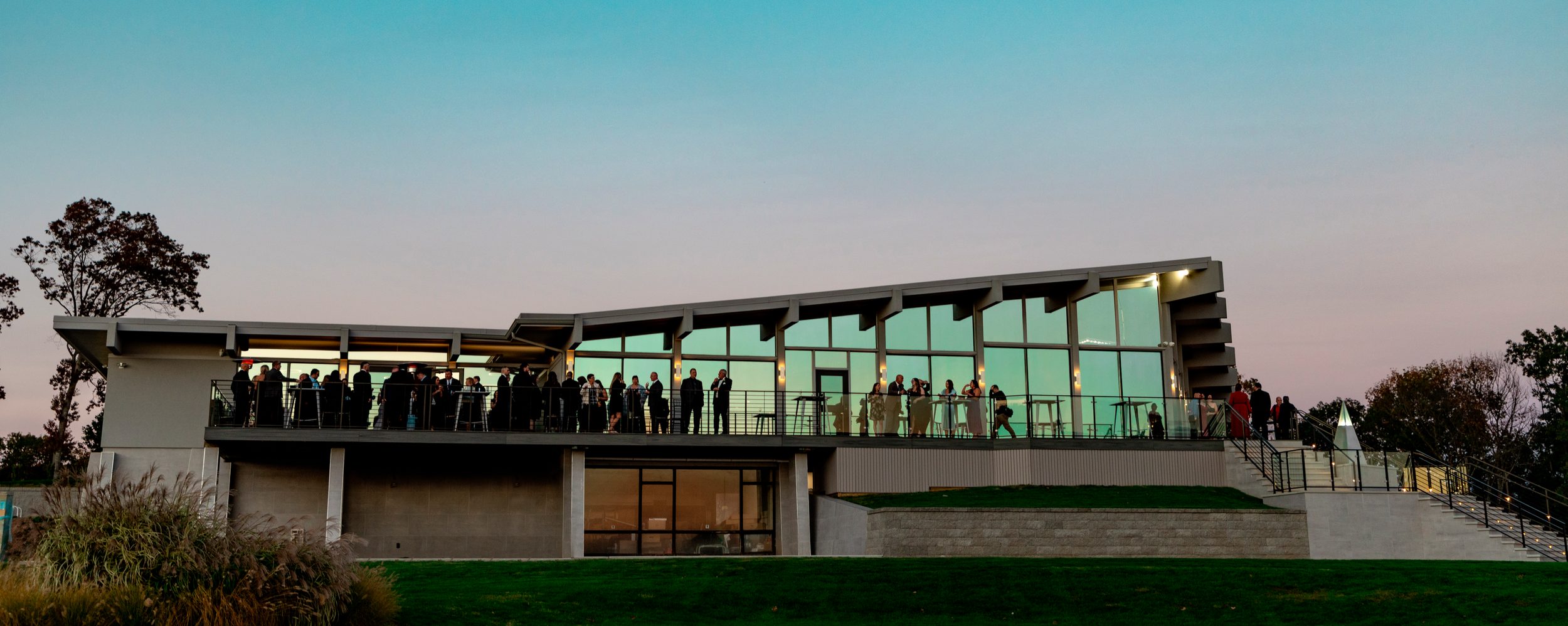 The VUE clubhouse lit up for an evening event at dusk in Hamden, CT