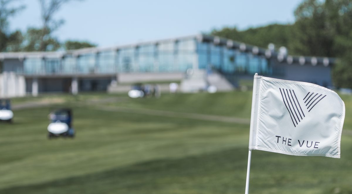 The VUE clubhouse overlooking the golf course in Hamden, CT, with The VUE pin flag in the foreground