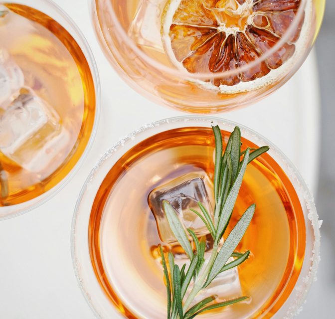 Citrus craft cocktails garnished with rosemary and dried orange served at The VUE