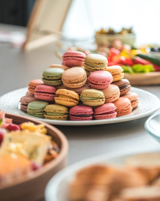 Tower of colorful macarons on a dessert display at an event at The VUE